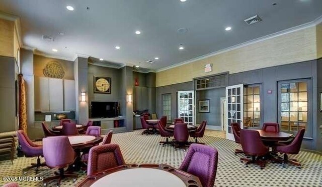 dining room featuring recessed lighting, carpet flooring, a high ceiling, and crown molding