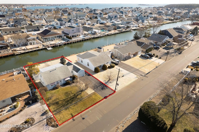 birds eye view of property featuring a residential view and a water view