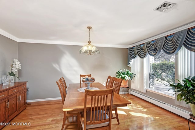 dining room featuring light wood-type flooring, visible vents, a baseboard heating unit, crown molding, and baseboards