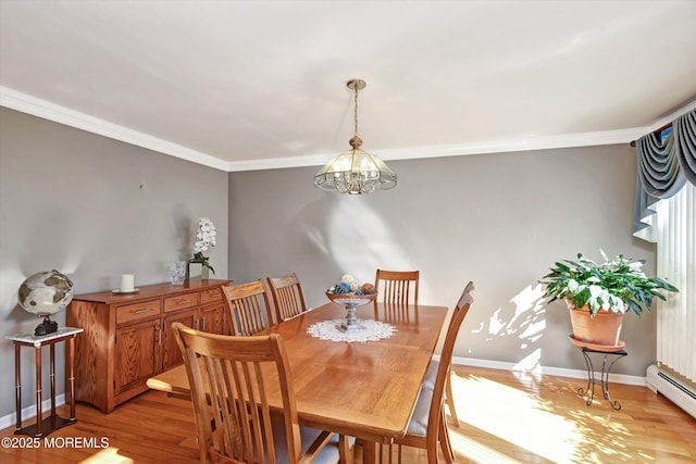 dining space with light wood-type flooring, baseboard heating, crown molding, and a notable chandelier