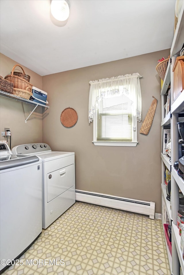 laundry area with light floors, baseboards, laundry area, a baseboard heating unit, and washing machine and dryer