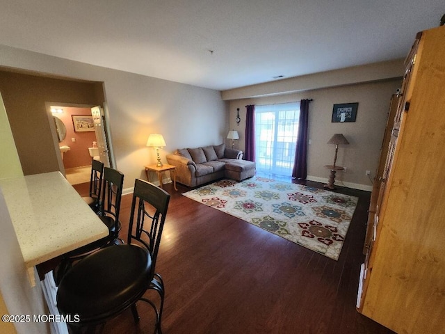 living room with visible vents, wood finished floors, and baseboards