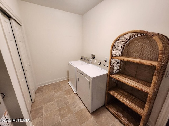 laundry room with laundry area, baseboards, and separate washer and dryer