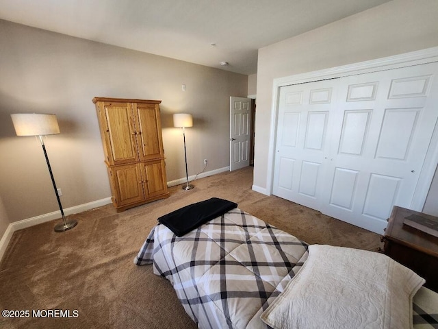 bedroom featuring a closet, baseboards, and light colored carpet