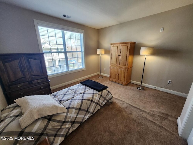 bedroom with visible vents, light carpet, and baseboards