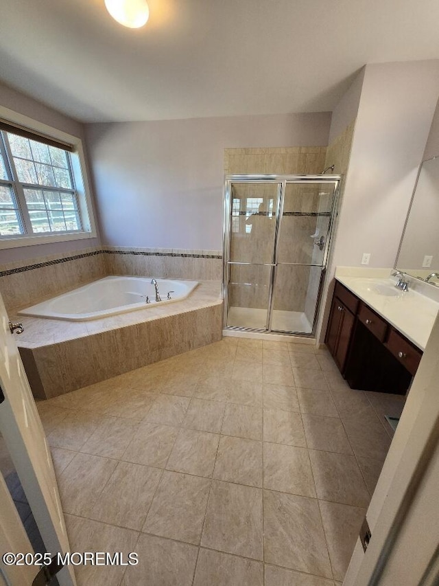 full bathroom with a bath, a shower stall, tile patterned floors, and vanity