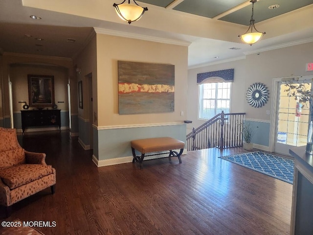 interior space with an upstairs landing, crown molding, baseboards, and wood finished floors