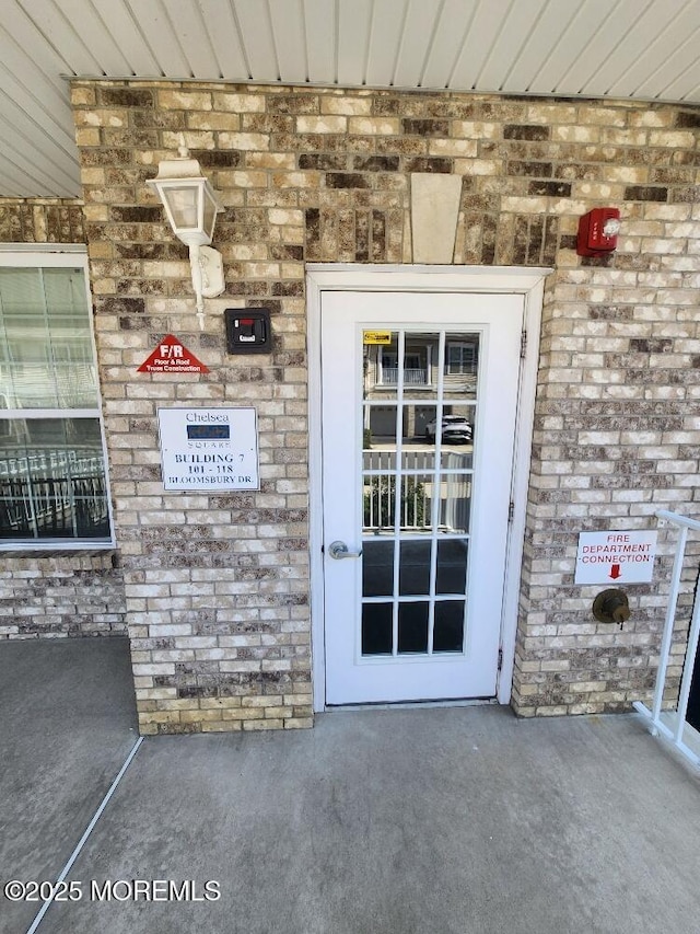 doorway to property with stone siding