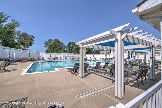 community pool featuring a patio area, a pergola, and fence