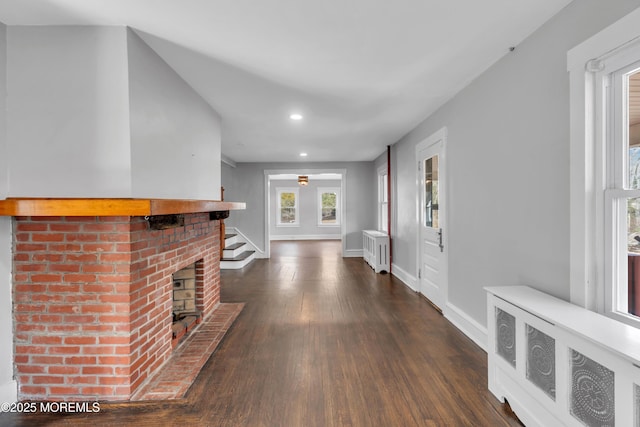 hall with stairway, radiator, baseboards, dark wood finished floors, and recessed lighting