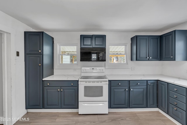 kitchen with a wealth of natural light, light stone counters, black microwave, and white electric range oven