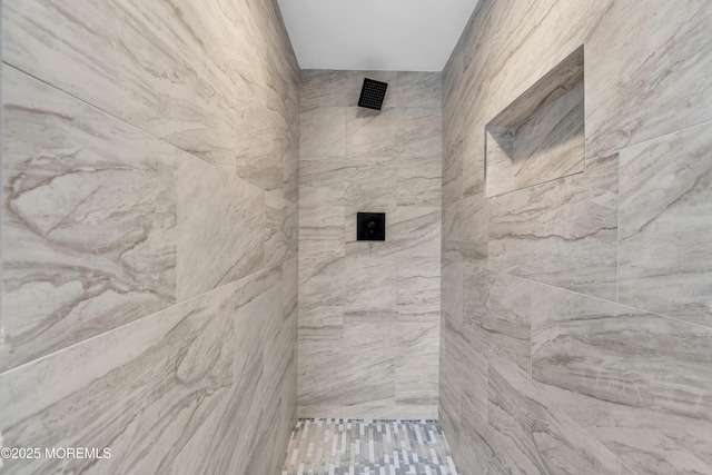 full bath featuring a tile shower