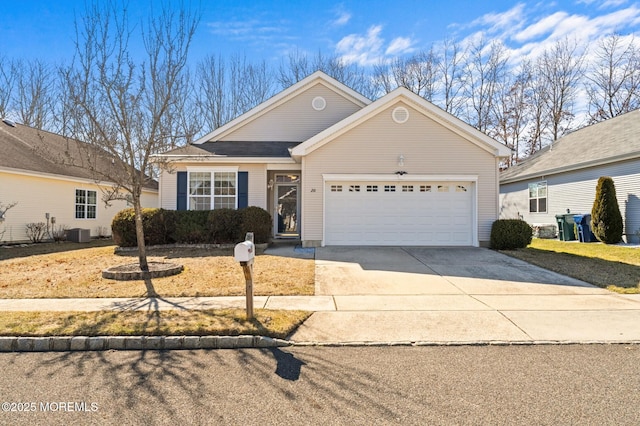 view of front facade featuring a garage, central AC, and concrete driveway