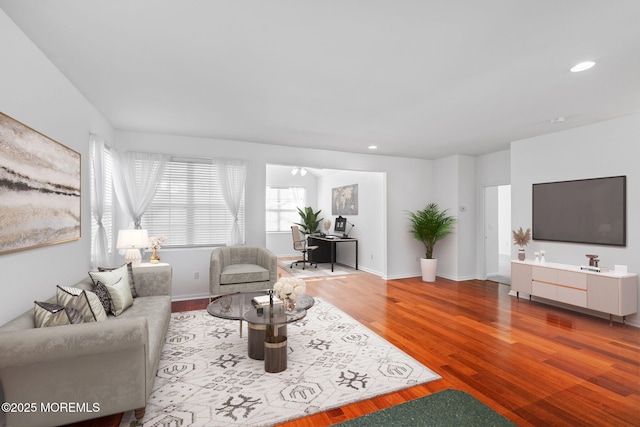 living room featuring recessed lighting, wood finished floors, and baseboards