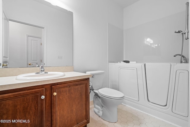 bathroom featuring tile patterned floors, toilet, walk in shower, and vanity