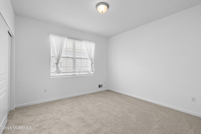 unfurnished bedroom featuring a closet, visible vents, baseboards, and carpet floors