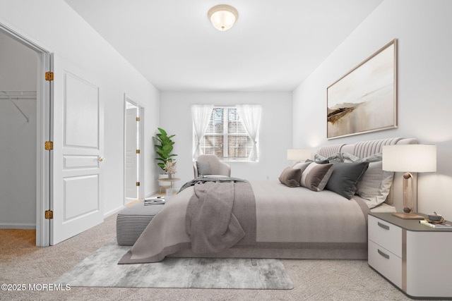 bedroom with a walk in closet and carpet flooring