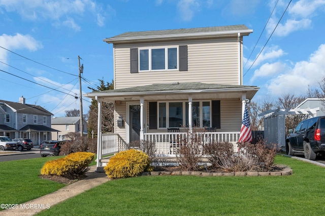 view of front of home with a porch and a front lawn