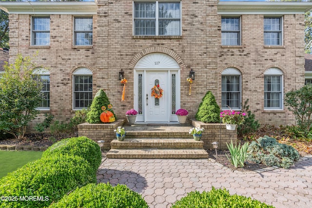 doorway to property with brick siding