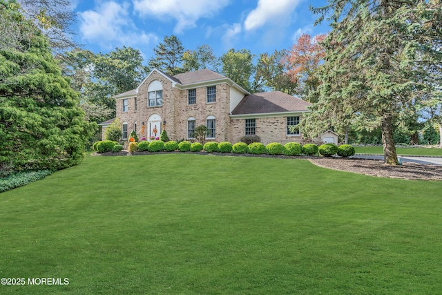 view of front of property with brick siding and a front yard