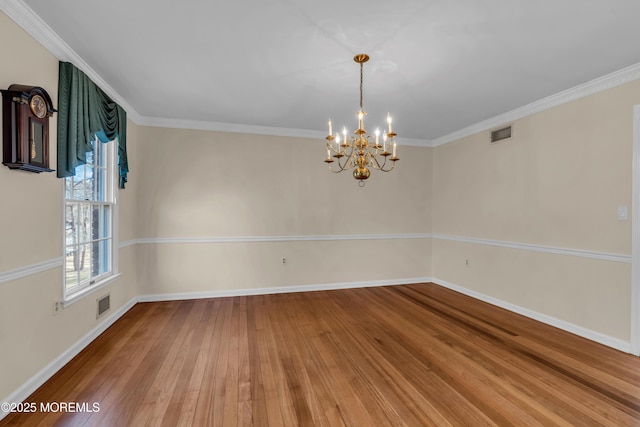 unfurnished room with visible vents, ornamental molding, and hardwood / wood-style floors