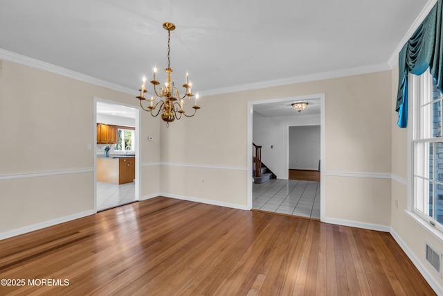 unfurnished room with stairway, baseboards, an inviting chandelier, light wood-style flooring, and crown molding