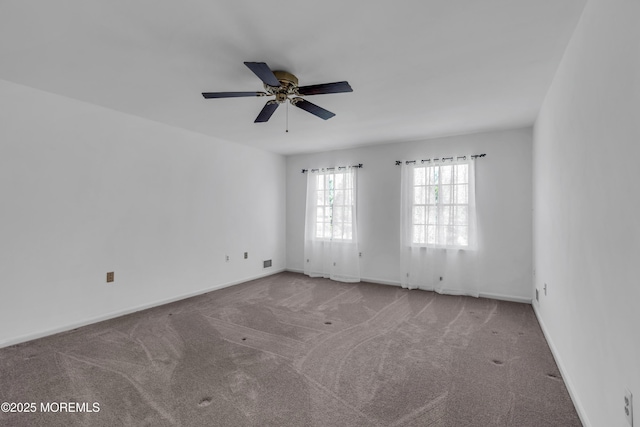 carpeted empty room with baseboards and ceiling fan