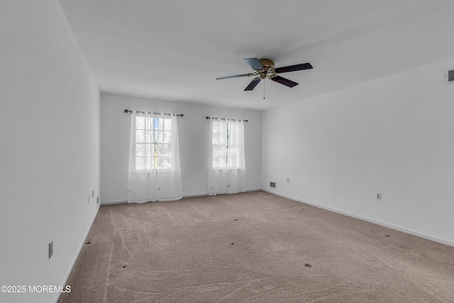 empty room featuring baseboards, carpet, and a ceiling fan