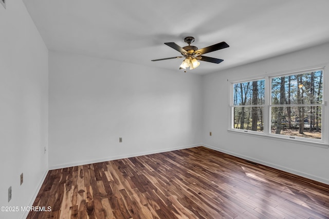 unfurnished room featuring ceiling fan, baseboards, and wood finished floors