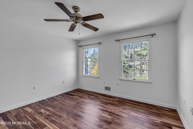 unfurnished room featuring visible vents, a ceiling fan, baseboards, and wood finished floors