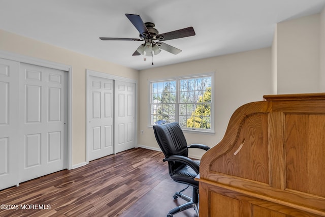 office area featuring dark wood-style floors, baseboards, and ceiling fan