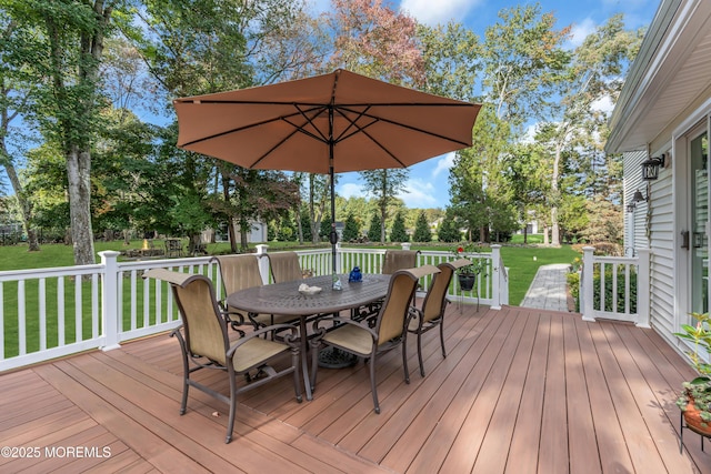 wooden terrace featuring a lawn and outdoor dining space