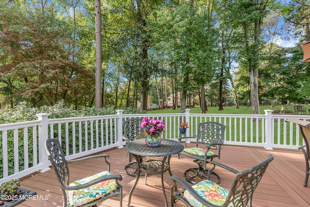 wooden deck featuring a yard