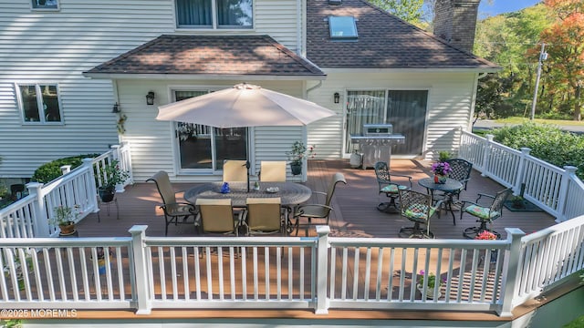 wooden deck featuring outdoor dining space