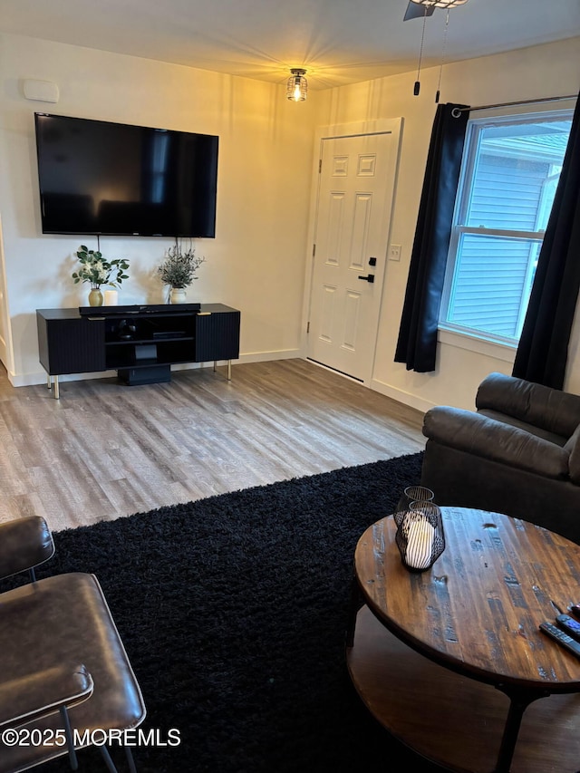 living room with wood finished floors and baseboards