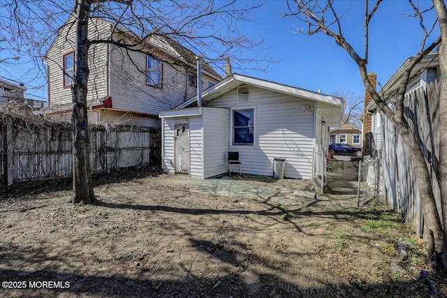 back of house featuring fence