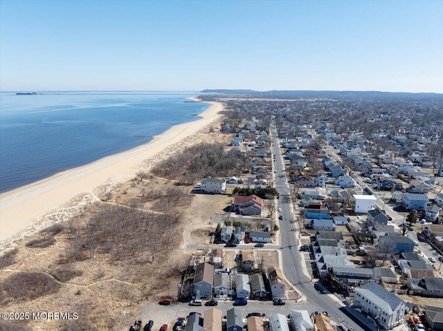 birds eye view of property featuring a water view and a view of the beach