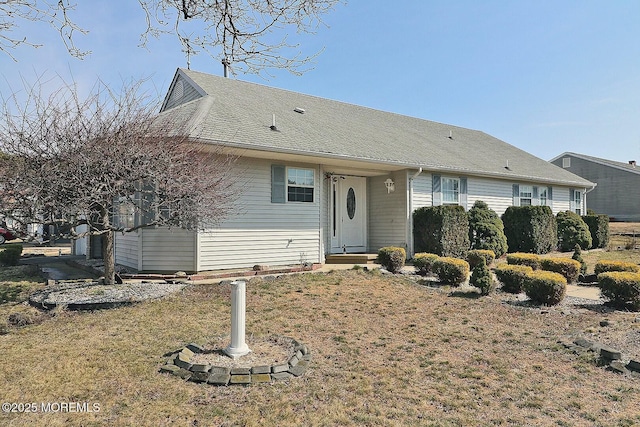 single story home featuring a shingled roof