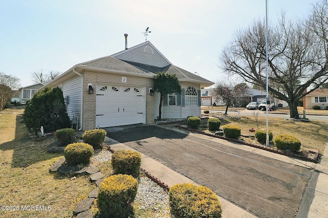 ranch-style house featuring an attached garage, brick siding, and driveway