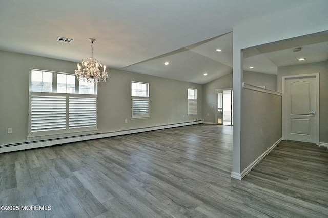 unfurnished room featuring visible vents, baseboards, baseboard heating, and wood finished floors