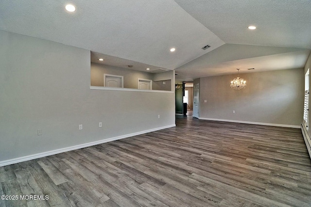 spare room with baseboards, lofted ceiling, visible vents, and dark wood finished floors