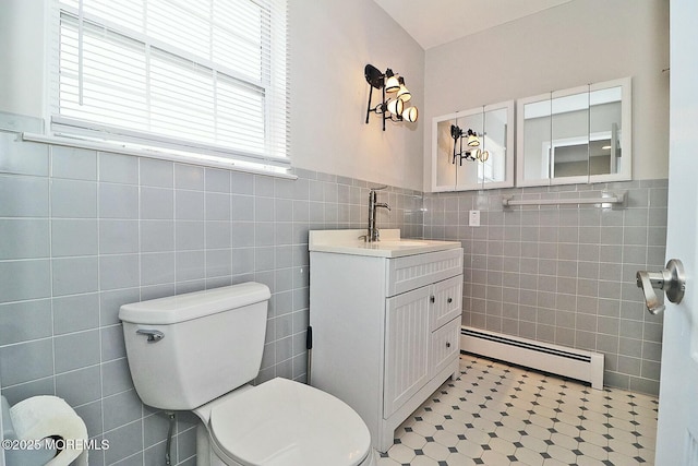 bathroom featuring vanity, a wealth of natural light, toilet, and baseboard heating