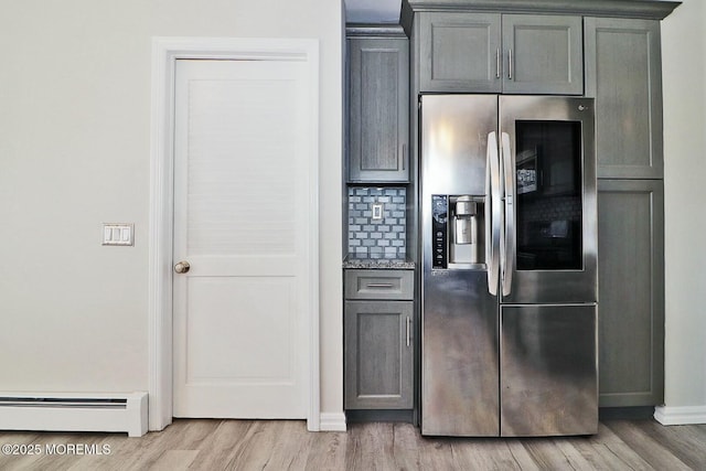 kitchen with a baseboard heating unit, stainless steel fridge with ice dispenser, gray cabinets, and light wood finished floors