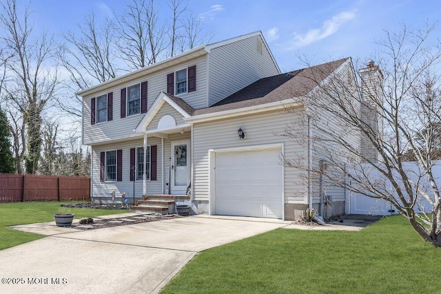 view of front of property featuring driveway, a front lawn, a garage, and fence