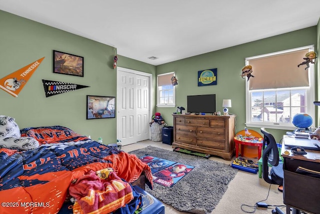 bedroom featuring a closet, visible vents, and carpet floors