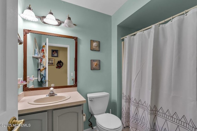 bathroom with a shower with curtain, toilet, and vanity