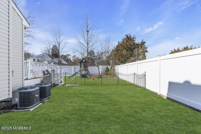 view of yard with central AC unit and a fenced backyard