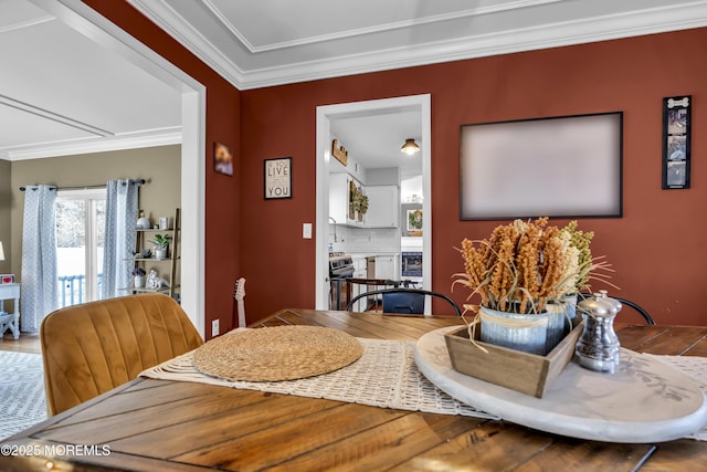 dining space featuring crown molding