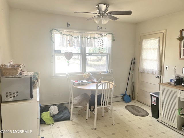 dining space featuring light floors and a ceiling fan