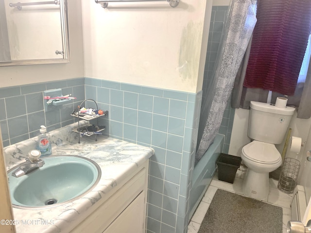 bathroom featuring toilet, tile walls, vanity, and tile patterned flooring